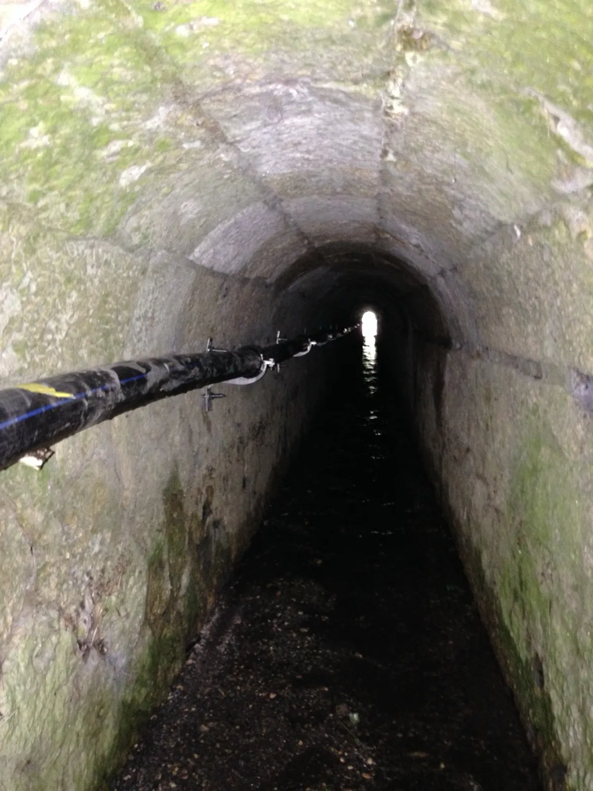 Canalisation supportée en encorbellement dans une galerie en sous-sol